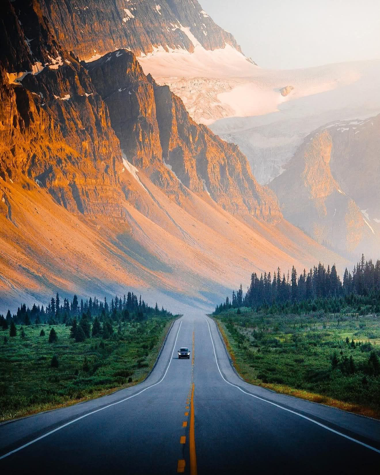 The Icefields Parkway beneath glacier-covered mountains