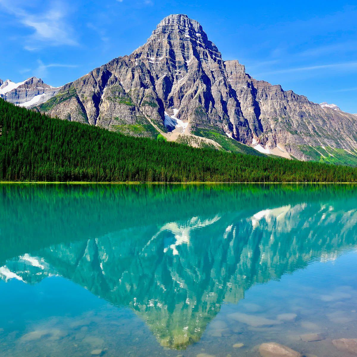 Turquoise mountain lake with a dramatic Rocky Mountain reflection